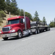 flatbed-semi-truck-hauling-wire-cargo-trucking-coil-freight-79875064